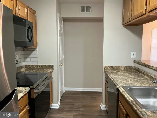 a view of a kitchen from the hallway