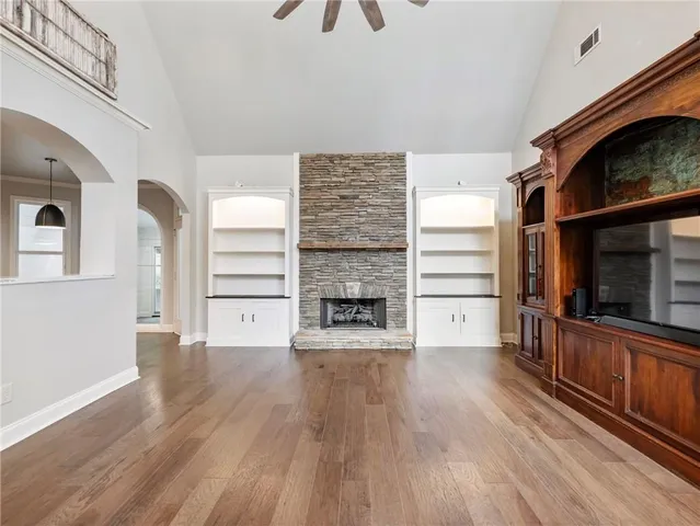 a view of a house with a big yard and large trees