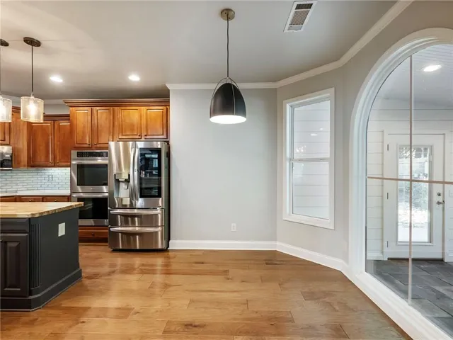 a view of a swimming pool with a patio and wooden fence
