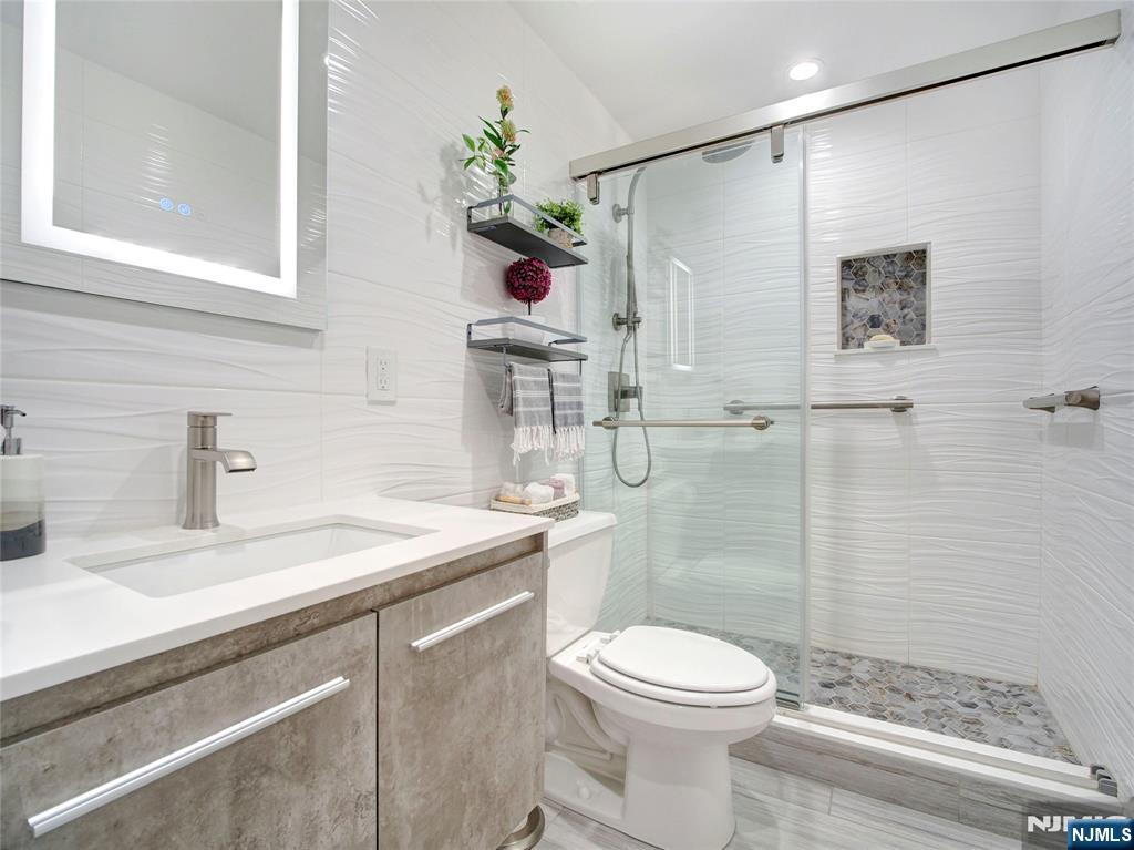 250 Gorge Road, Unit 17L Cliffside Park, NJ 07010 - Photo 14 of 30 a bathroom with a sink a toilet and shower