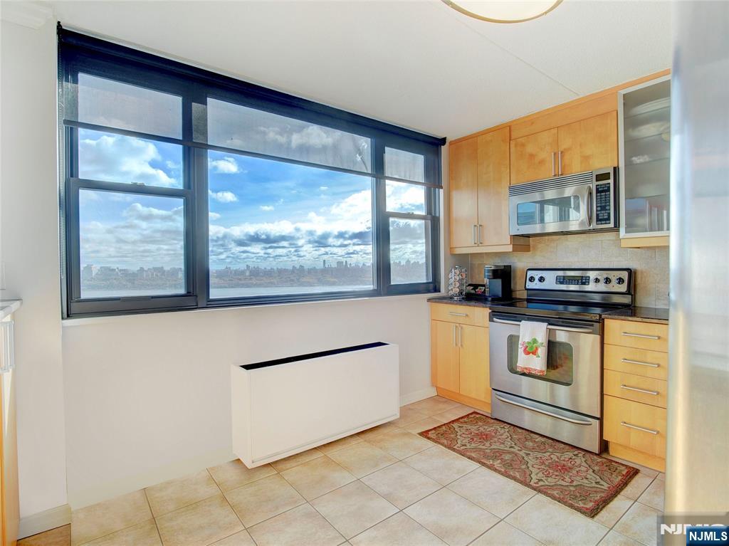 250 Gorge Road, Unit 17L Cliffside Park, NJ 07010 - Photo 6 of 30 a kitchen with stainless steel appliances granite countertop a stove a sink and a refrigerator