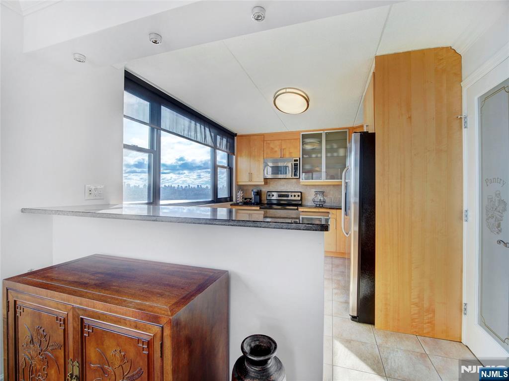 250 Gorge Road, Unit 17L Cliffside Park, NJ 07010 - Photo 8 of 30 a kitchen with stainless steel appliances a refrigerator a stove a sink and a window