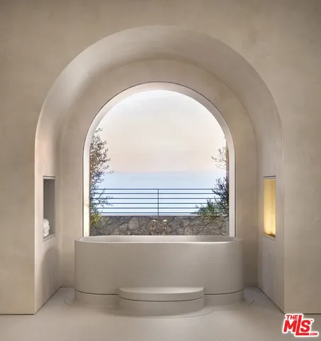 a living room with fireplace furniture and a large window