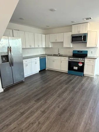 a kitchen with stainless steel appliances cabinets a sink and a stove