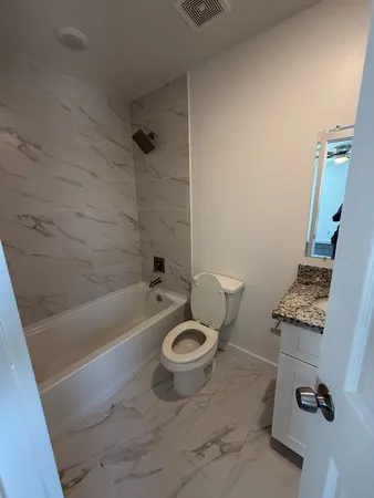 a bathroom with a toilet a sink and bathtub