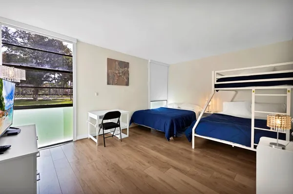 a bedroom with furniture and a chair