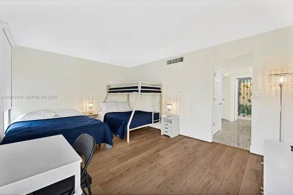 a bedroom with furniture and a chair