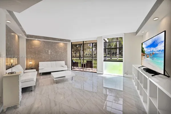 a living room with furniture and a flat screen tv