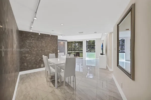 a view of a dining room with furniture and window