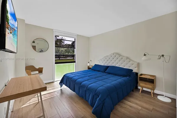 a bedroom with a bed and a window