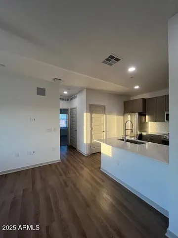 a view of kitchen with sink and wooden floor
