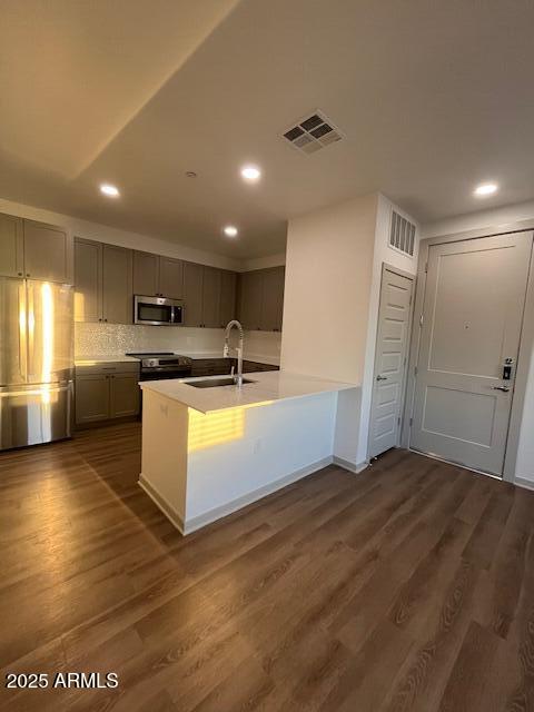 1225 North Arizona Avenue, Unit A4 Gilbert, AZ 85233 - Photo 4 of 23 a large kitchen with stainless steel appliances kitchen island a large counter top and a stove top oven