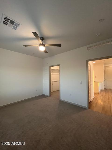 1225 North Arizona Avenue, Unit A4 Gilbert, AZ 85233 - Photo 7 of 23 an empty room with a ceiling fan and windows