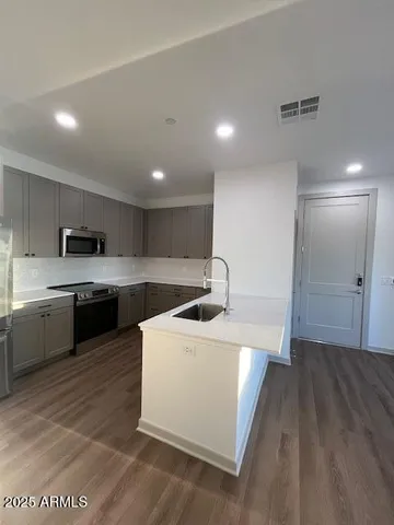 a kitchen with a sink a stove and cabinets