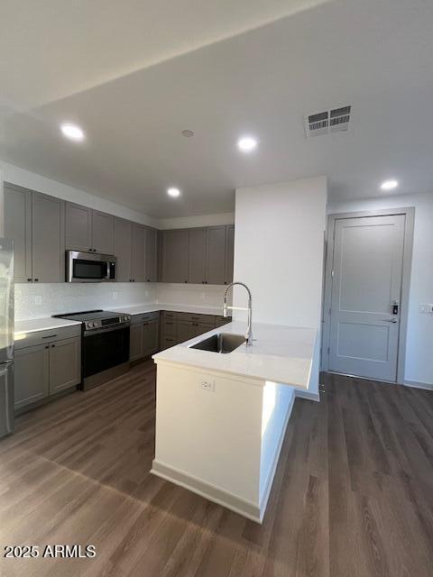 1225 North Arizona Avenue, Unit A4 Gilbert, AZ 85233 - Photo 10 of 23 a kitchen with a sink a stove and cabinets
