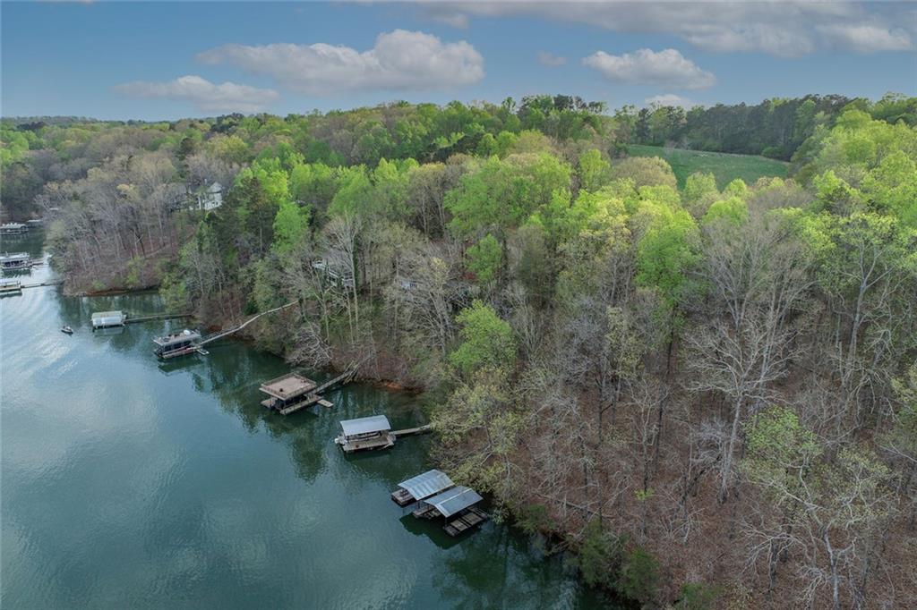 an aerial view of a house with a yard and lake view
