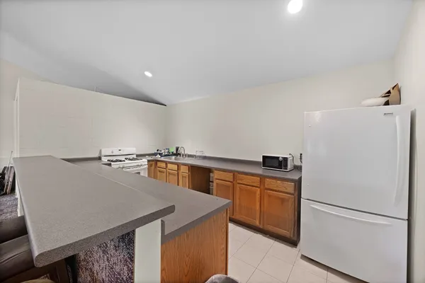 a bathroom with a granite countertop toilet and a shower