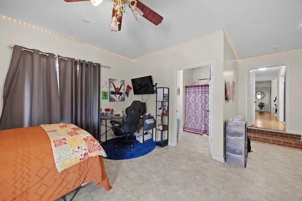a large kitchen with stainless steel appliances granite countertop a stove top oven a sink dishwasher a dining table and chairs with wooden floor