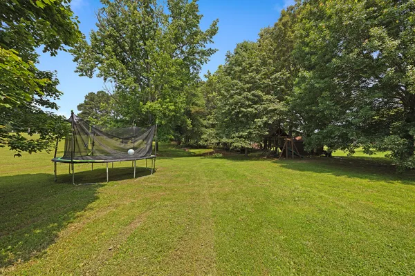 a front view of house with yard and swimming pool
