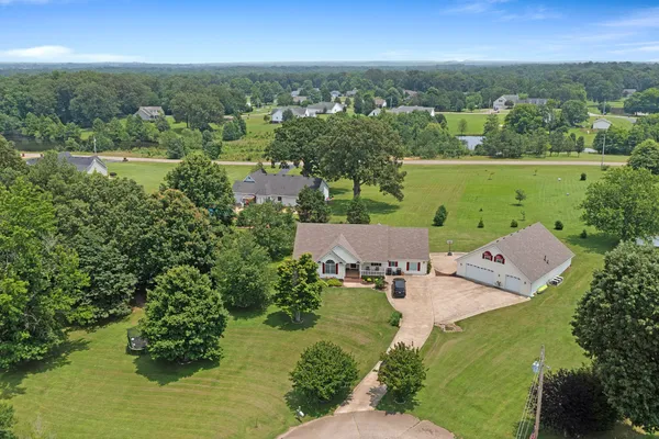 an aerial view of a house with a yard