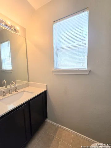 a bathroom with a sink vanity and a mirror