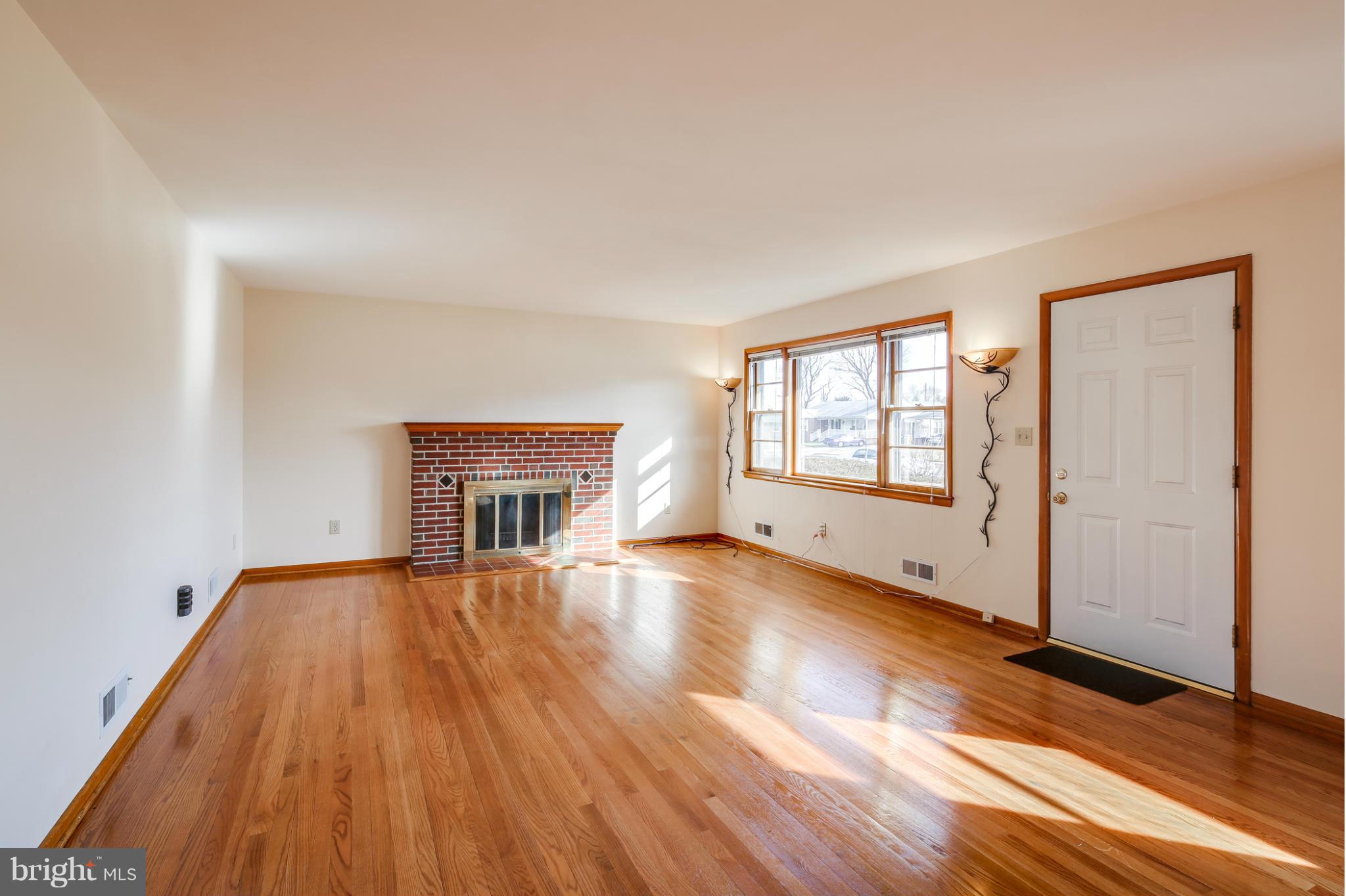 700 East Maple Road Linthicum, MD 21090 - Photo 2 of 29 an empty room with wooden floor and windows