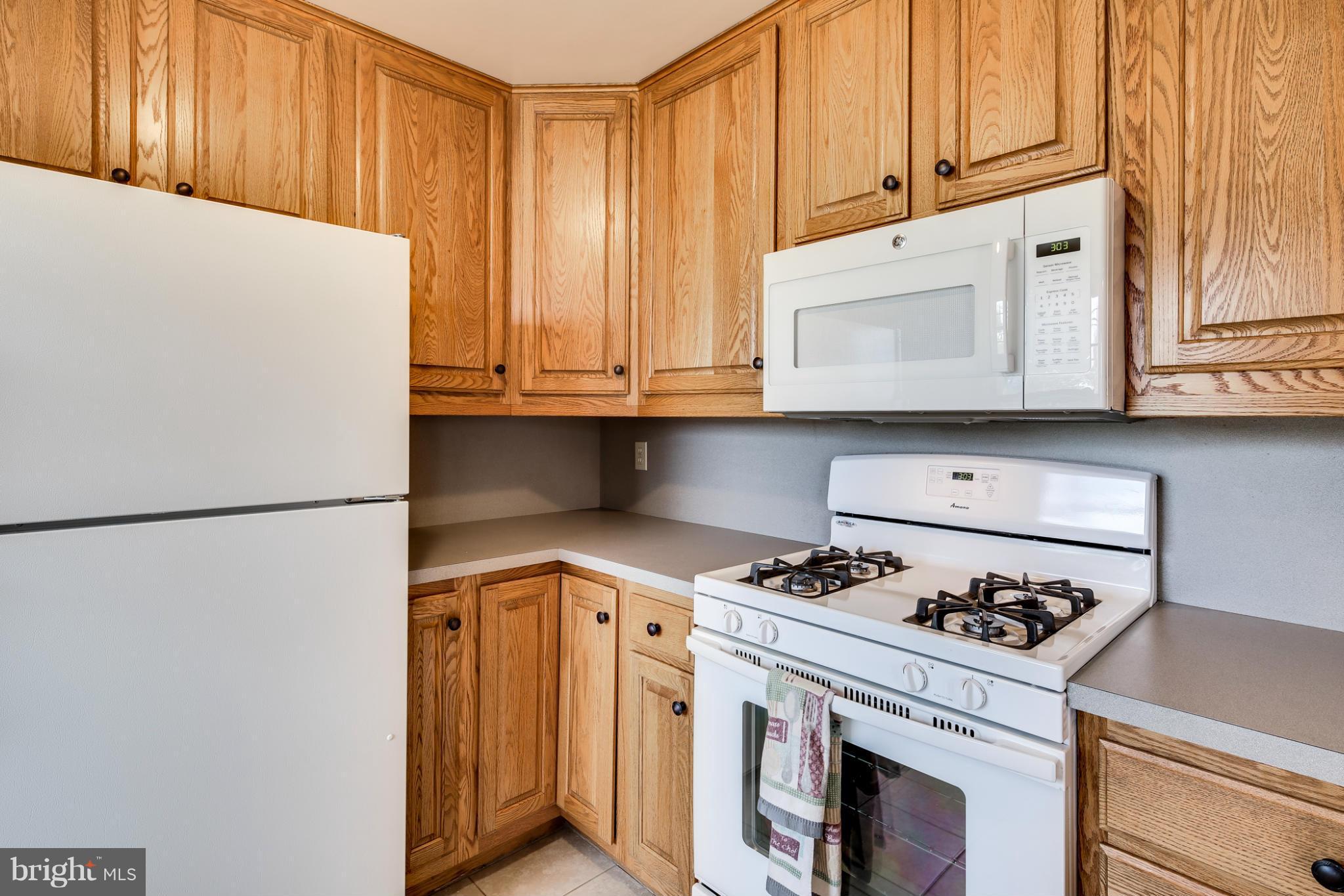 700 East Maple Road Linthicum, MD 21090 - Photo 11 of 29 a kitchen with stainless steel appliances granite countertop a refrigerator and a stove