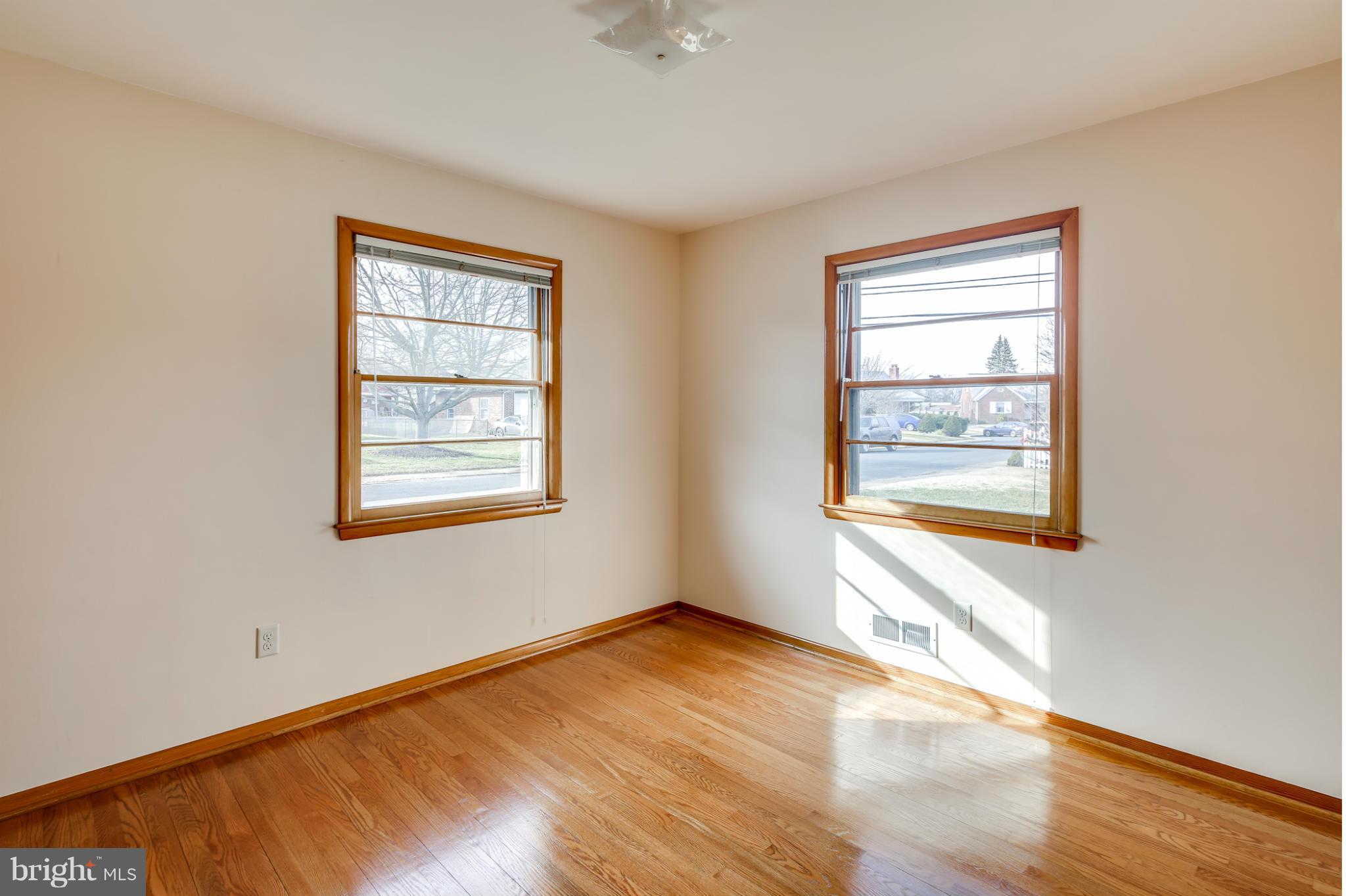 700 East Maple Road Linthicum, MD 21090 - Photo 16 of 29 a view of an empty room with wooden floor and a window