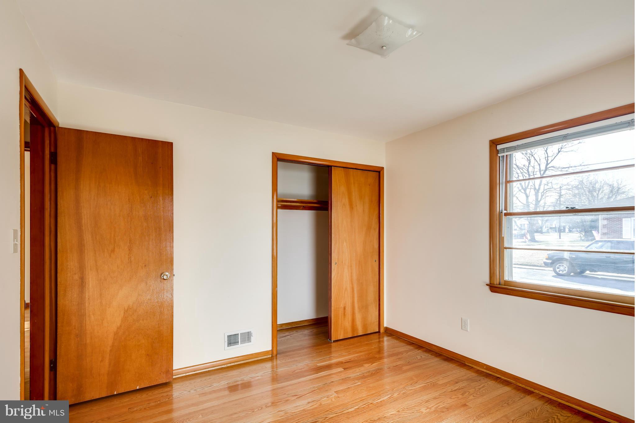 700 East Maple Road Linthicum, MD 21090 - Photo 17 of 29 an empty room with wooden floor and windows