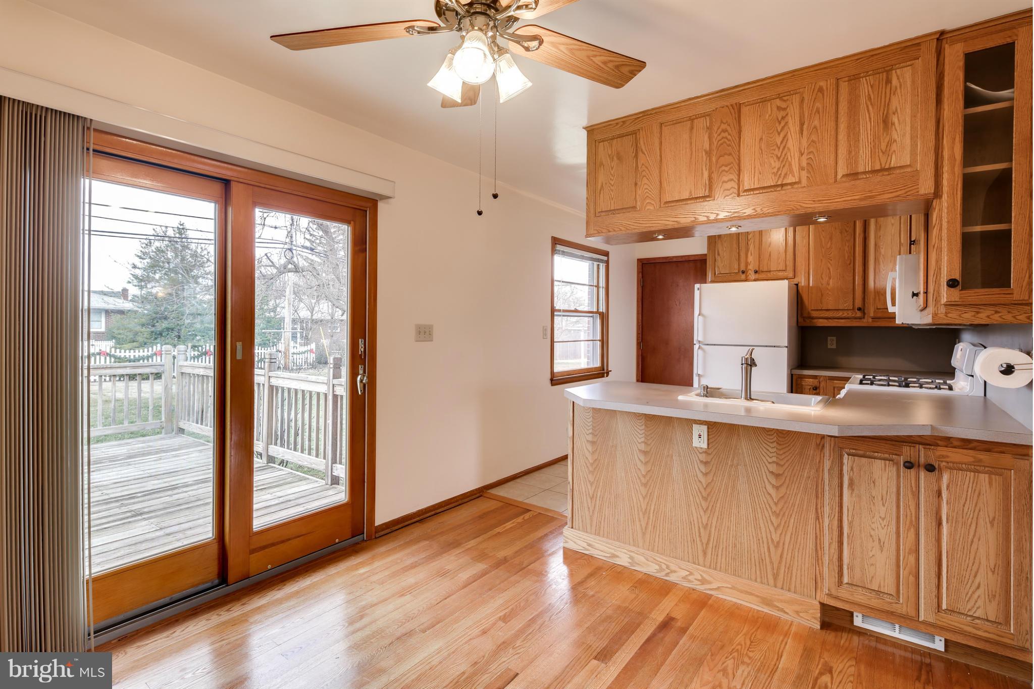 700 East Maple Road Linthicum, MD 21090 - Photo 7 of 29 a kitchen with stainless steel appliances granite countertop a stove a sink and a refrigerator