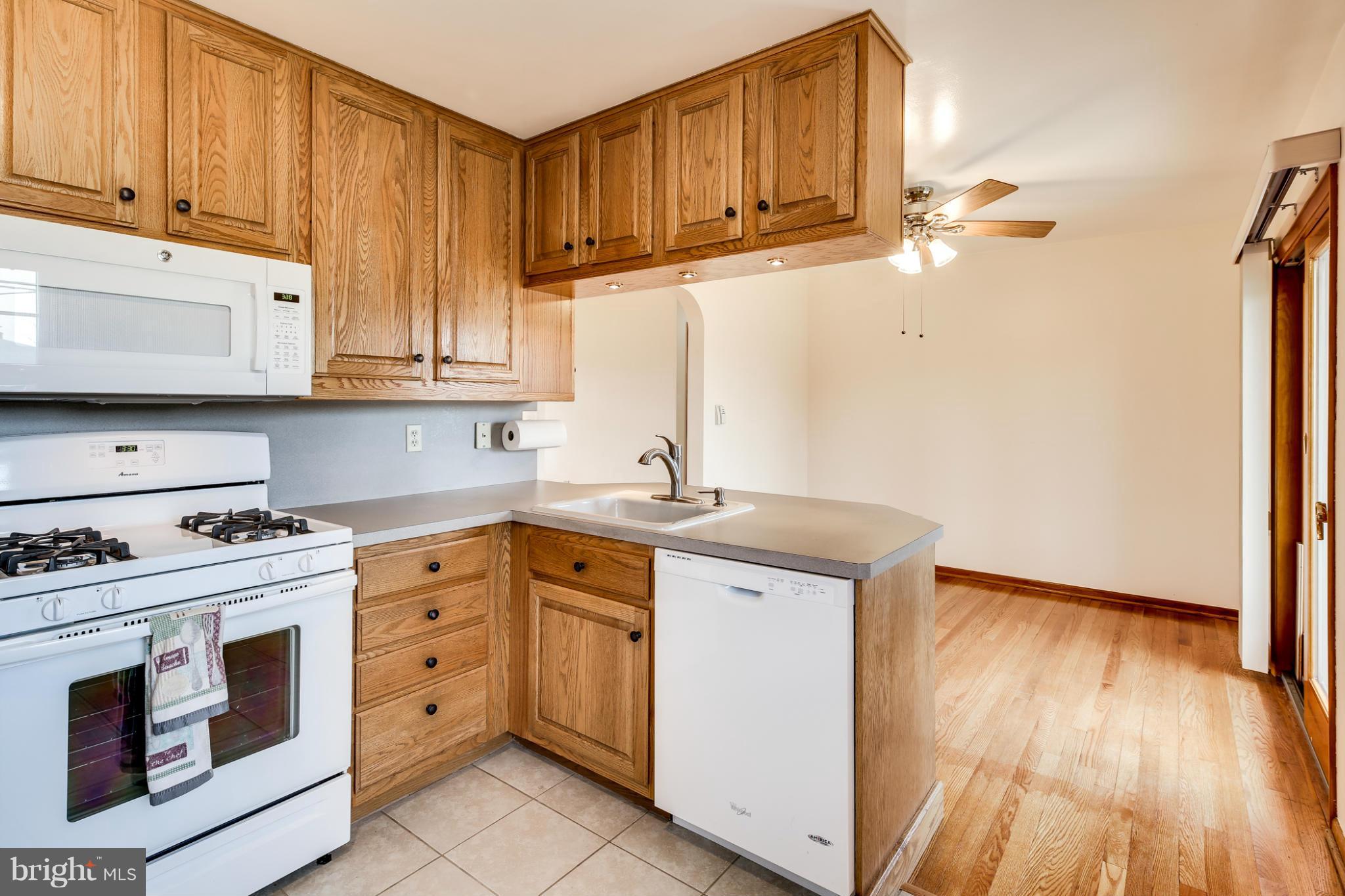 700 East Maple Road Linthicum, MD 21090 - Photo 8 of 29 a kitchen with stainless steel appliances granite countertop a sink stove and cabinets