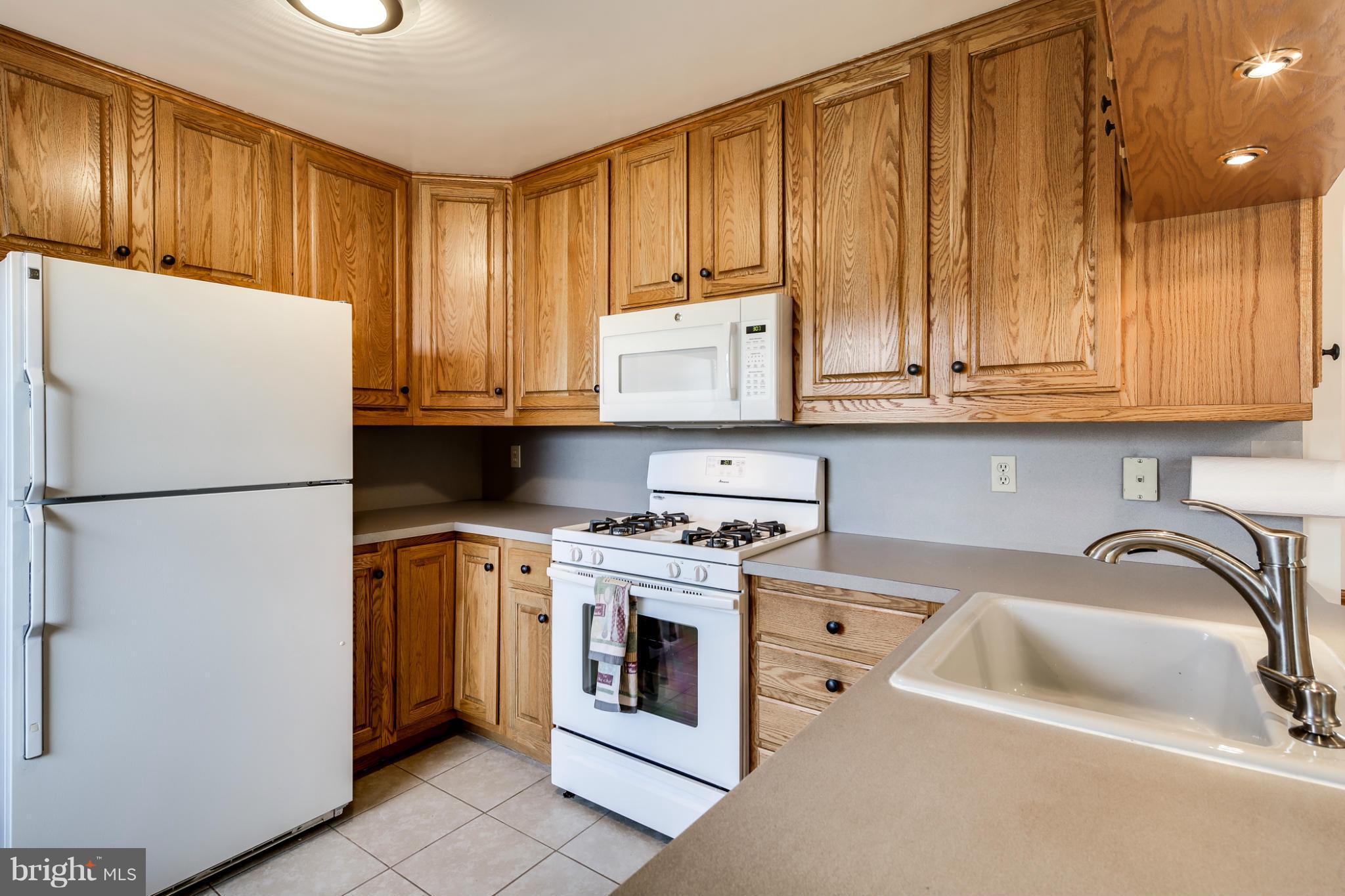 700 East Maple Road Linthicum, MD 21090 - Photo 9 of 29 a kitchen with stainless steel appliances granite countertop a refrigerator a sink a stove and a refrigerator