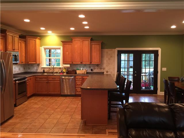 1041 Long Shot Drive Springfield, TN 37172 - Photo 6 of 18 KITCHEN HAS ISLAND WITH BAR OVERHANG FOR EXTRA SEATING; TILE FLOOR, STAINLESS STEEL APPLIANCES