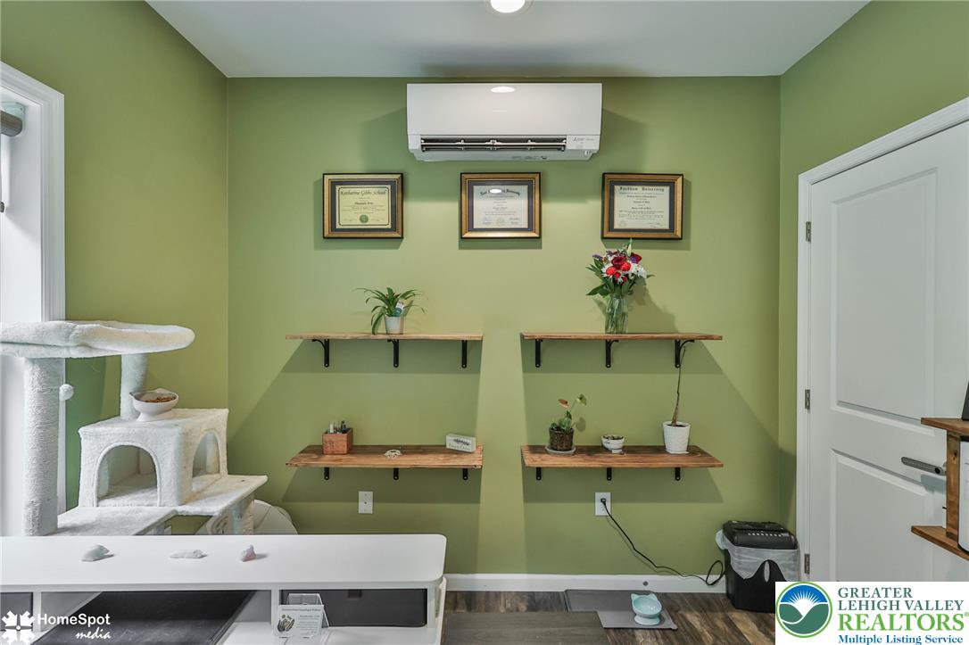 318 Church Road Kunkletown, PA 18058 - Photo 35 of 51 A well-lit room offers functional wall-mounted shelving and durable wood flooring.