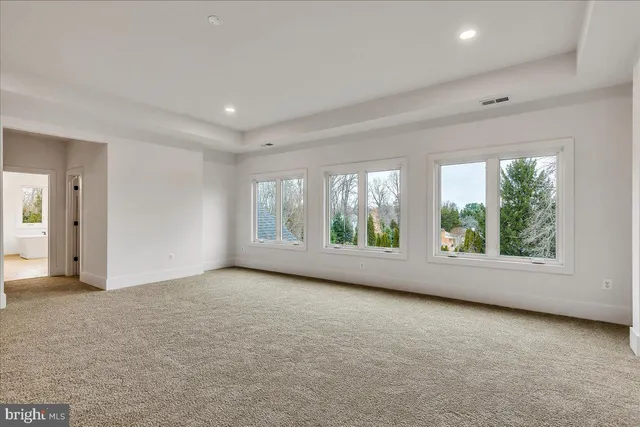 a spacious bathroom with a double vanity sink mirror and bathtub