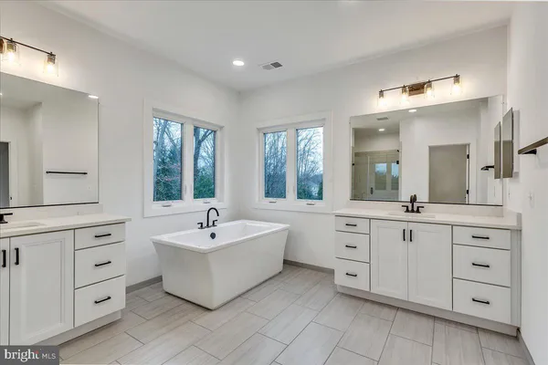 a white bath tub sitting next to a window