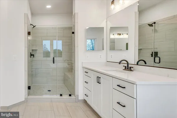 a bathroom with a sink toilet a mirror and shower