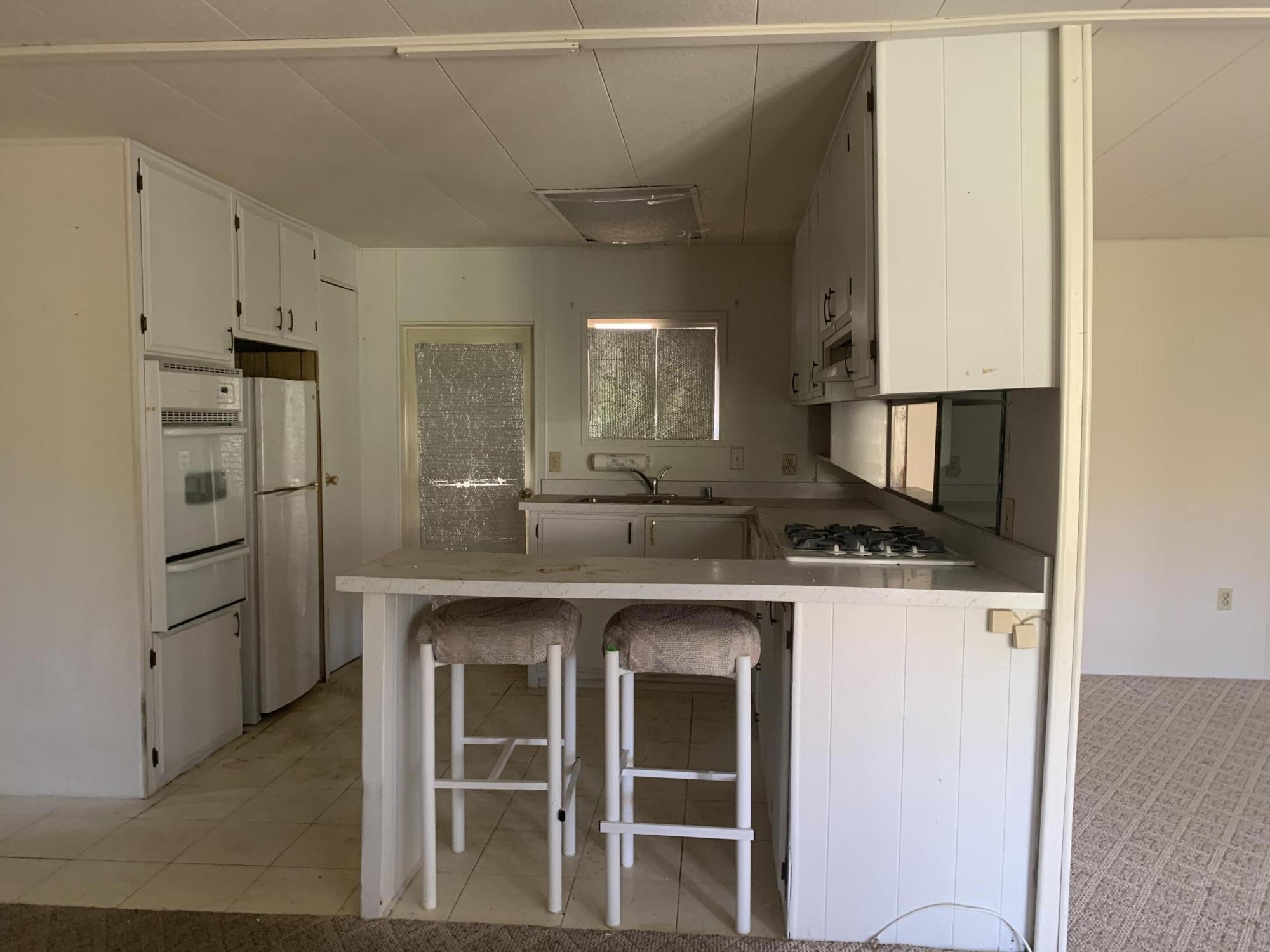 69430 Fairway Road Desert Hot Springs, CA 92241 - Photo 14 of 21 a kitchen with stainless steel appliances granite countertop a refrigerator and a stove