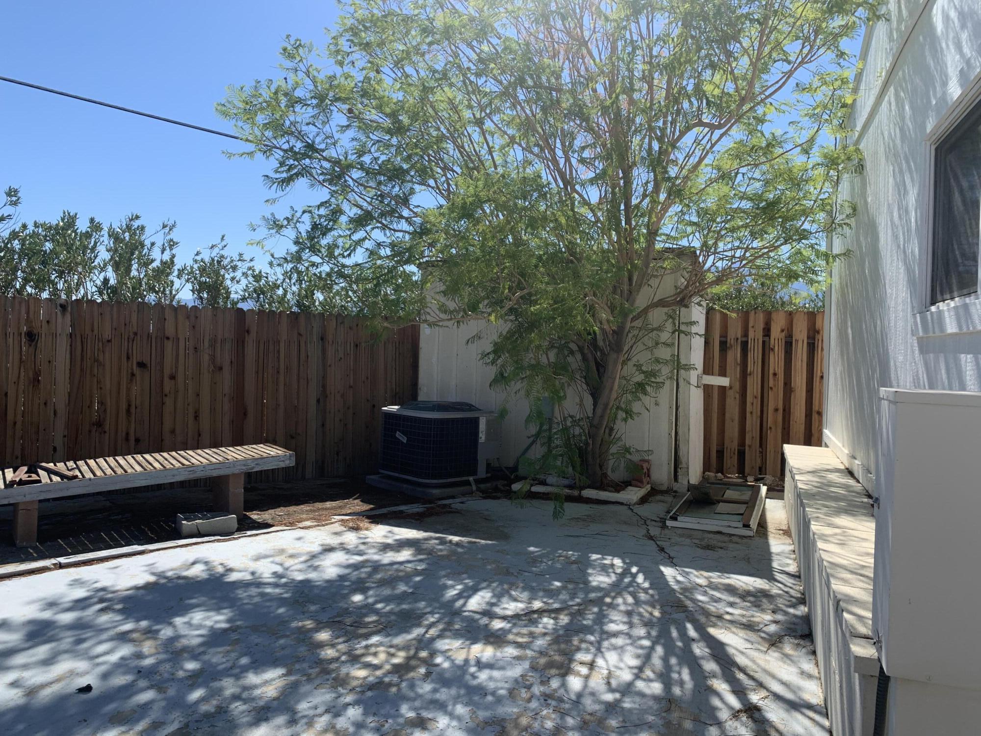 69430 Fairway Road Desert Hot Springs, CA 92241 - Photo 9 of 21 a backyard of a house with table and chairs