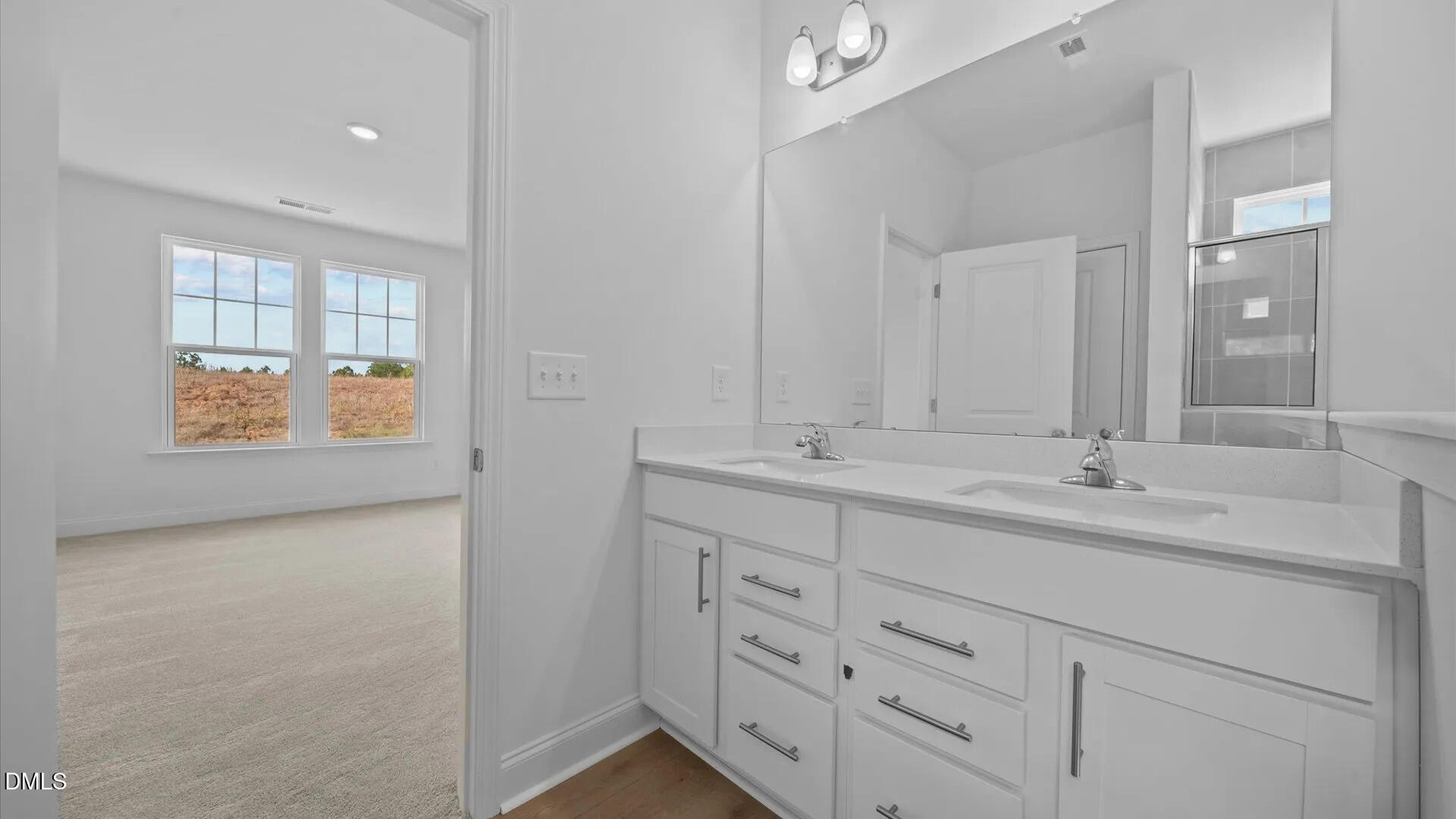 23 Gerrad Street, Unit 68 Franklinton, NC 27525 - Photo 18 of 23 a bathroom with double sink and a mirror