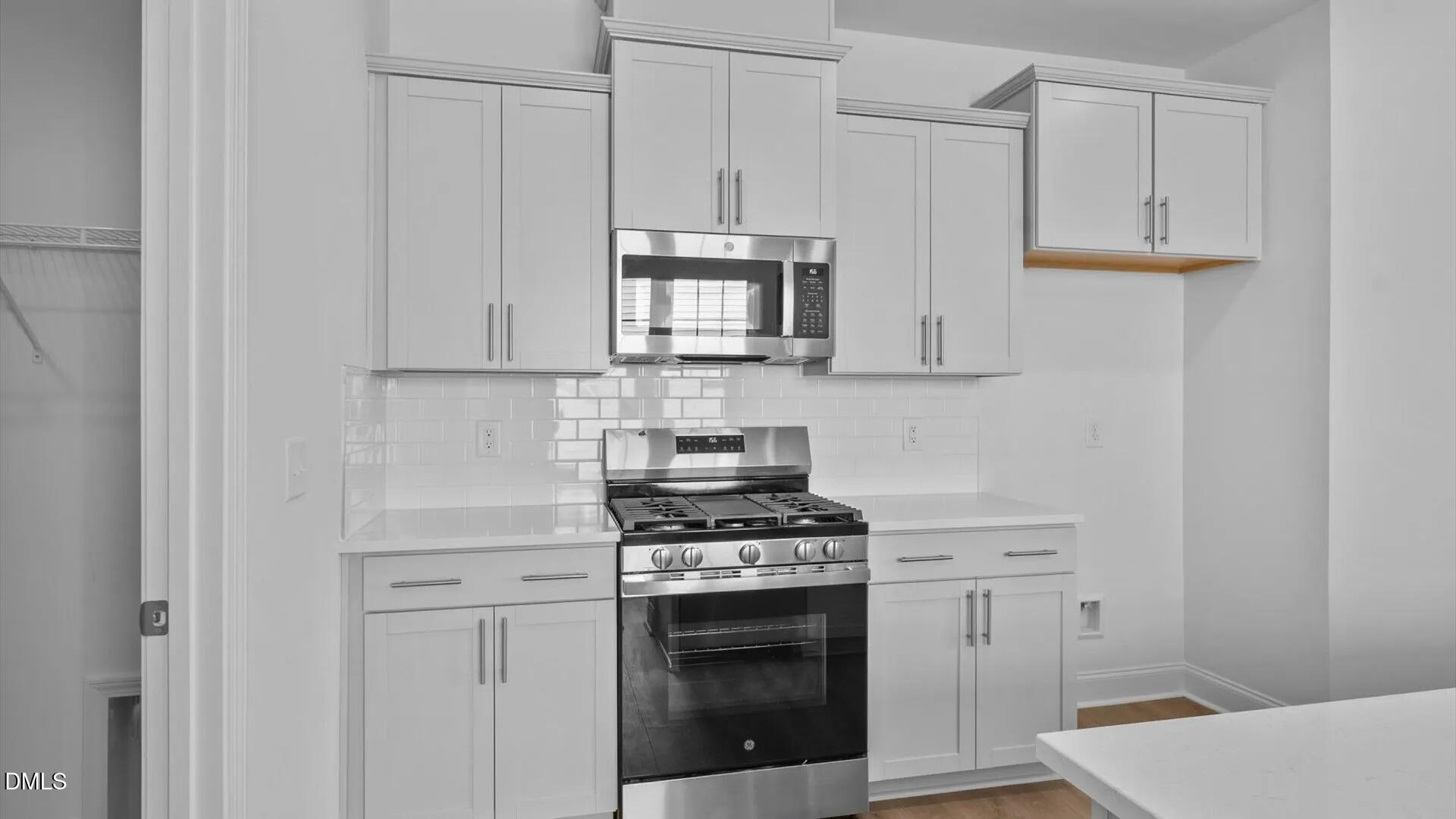 23 Gerrad Street, Unit 68 Franklinton, NC 27525 - Photo 5 of 23 a kitchen with granite countertop white cabinets and stainless steel appliances