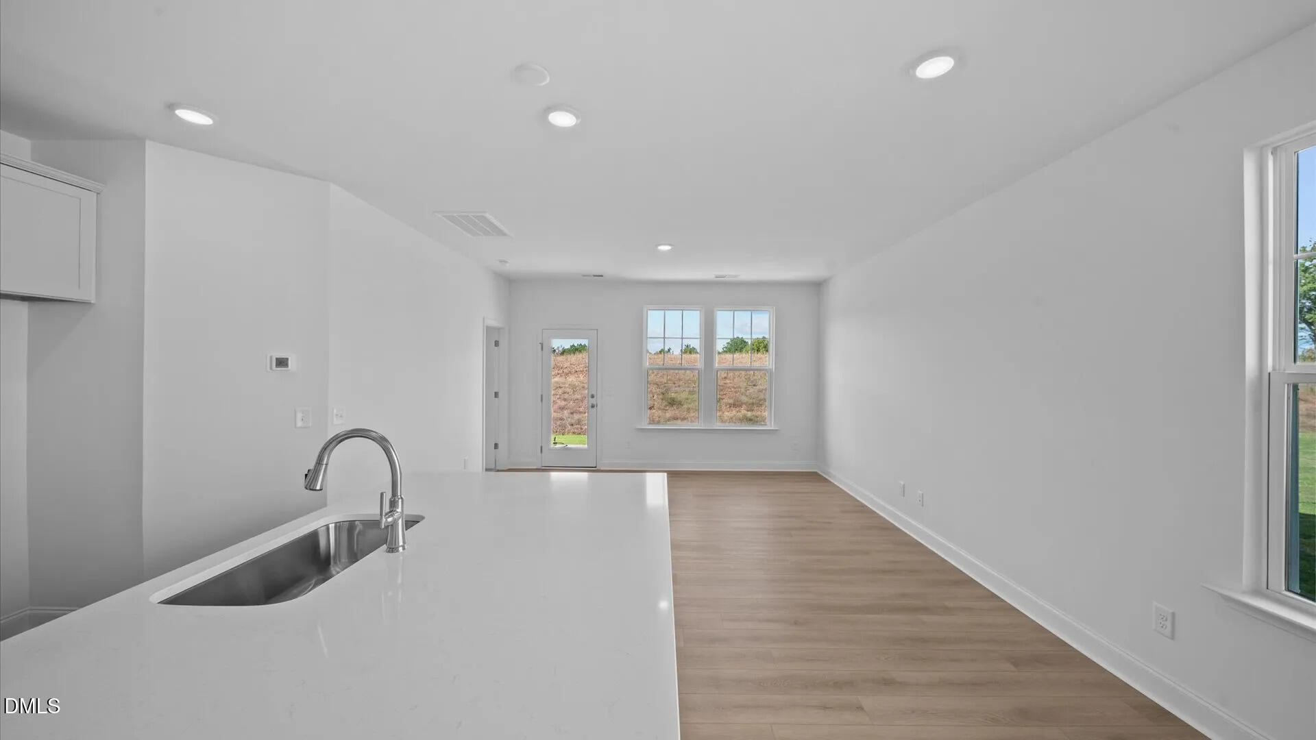 23 Gerrad Street, Unit 68 Franklinton, NC 27525 - Photo 6 of 23 a view of an empty room with glass door and wooden floor