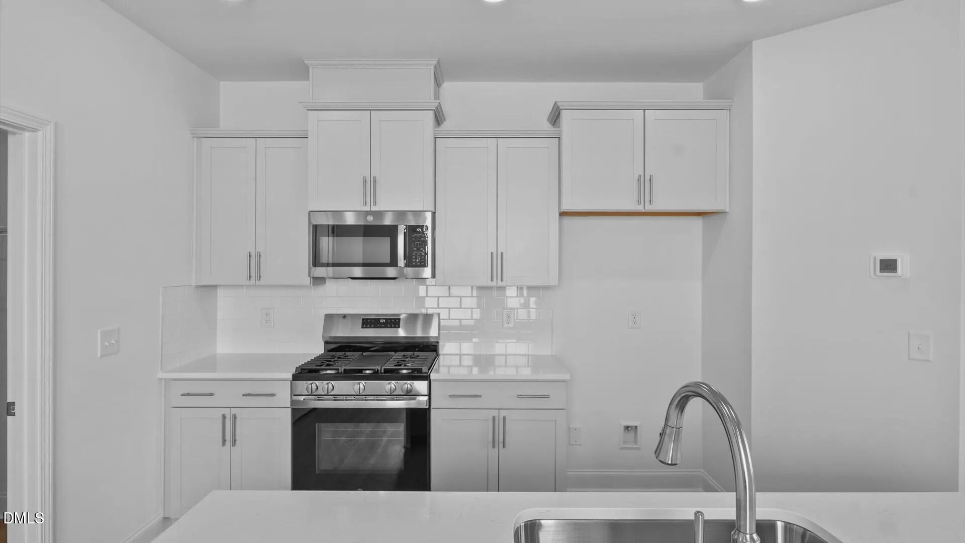 23 Gerrad Street, Unit 68 Franklinton, NC 27525 - Photo 8 of 23 a kitchen with stainless steel appliances granite countertop a stove a sink and a refrigerator