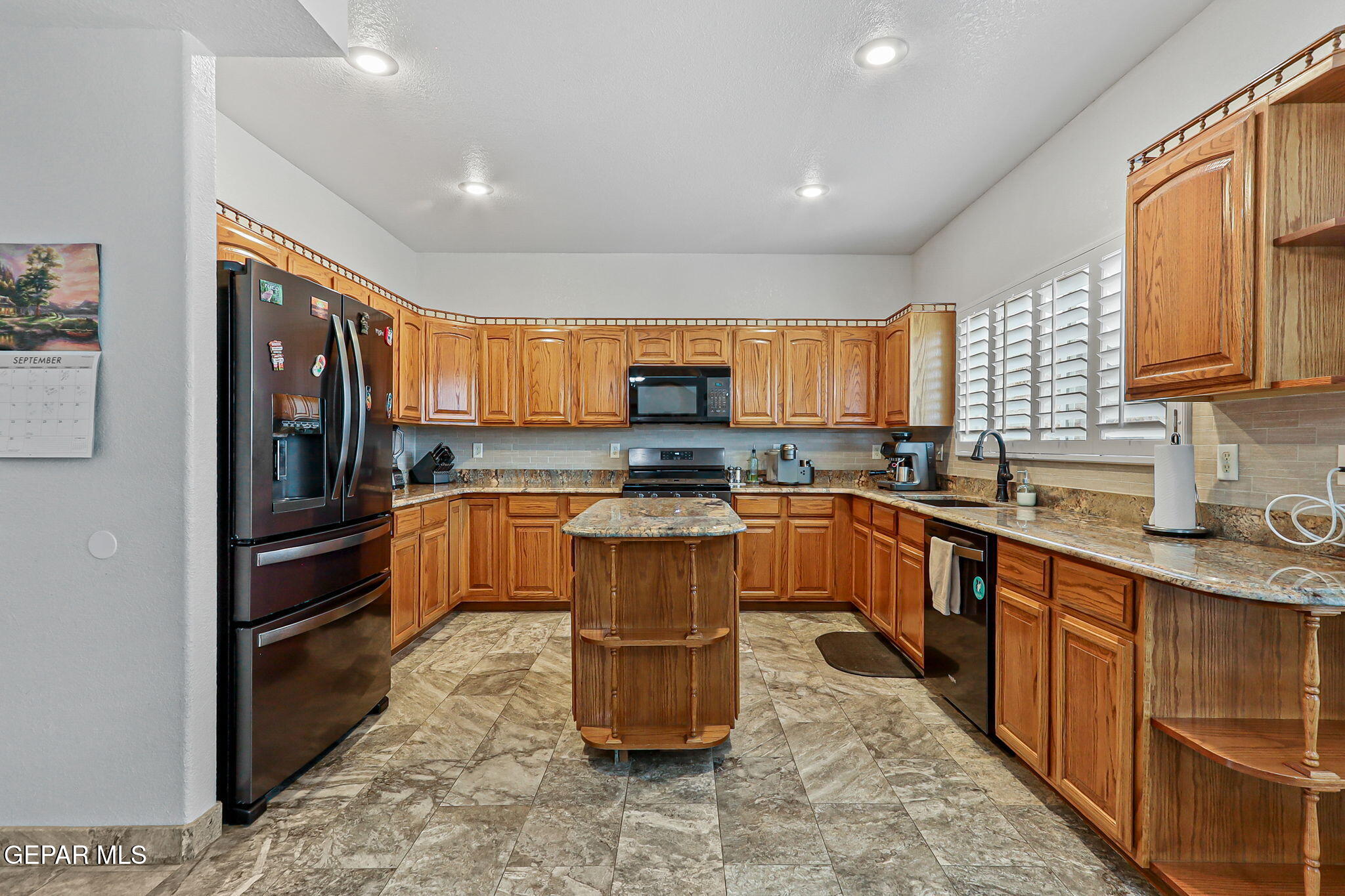 6544 Royal Ridge Drive El Paso, TX 79912 - Photo 17 of 58 a kitchen with granite countertop a refrigerator stove top oven and sink