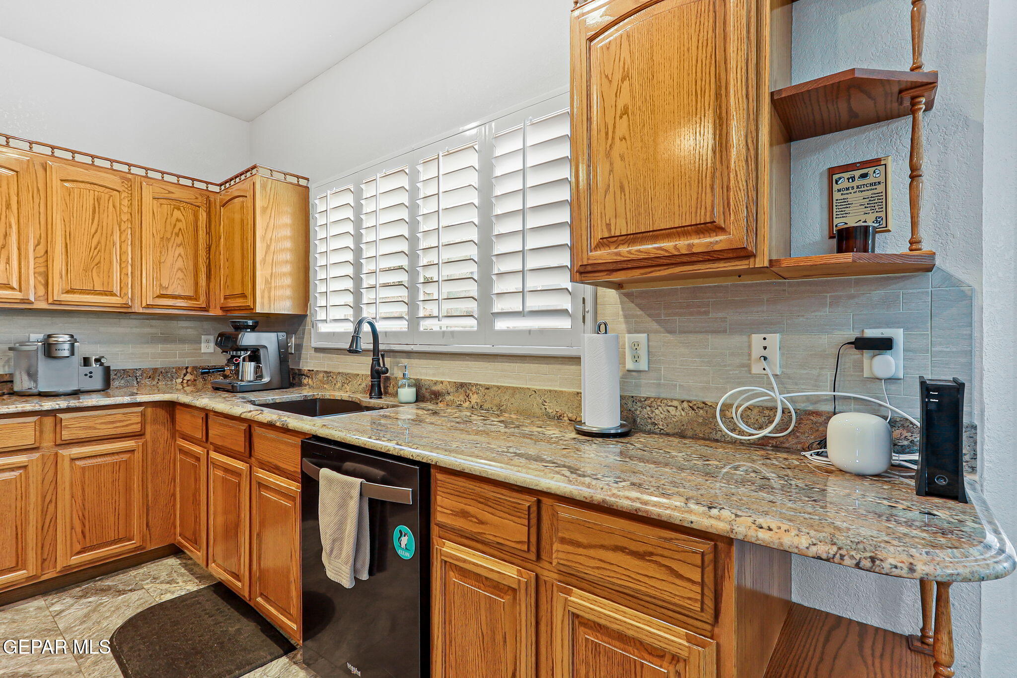 6544 Royal Ridge Drive El Paso, TX 79912 - Photo 18 of 58 a kitchen with granite countertop a sink and a window