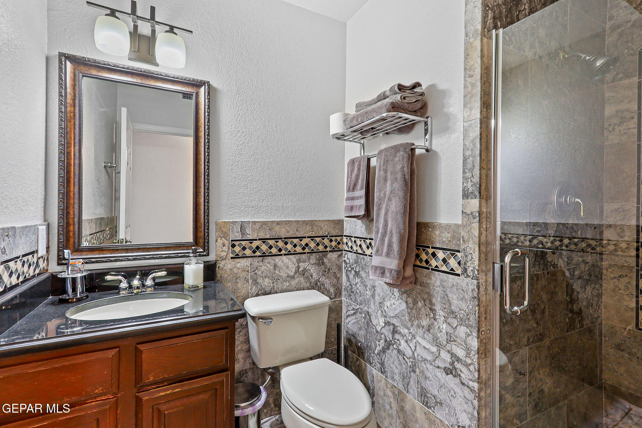 6544 Royal Ridge Drive El Paso, TX 79912 - Photo 25 of 58 a bathroom with a toilet sink and mirror