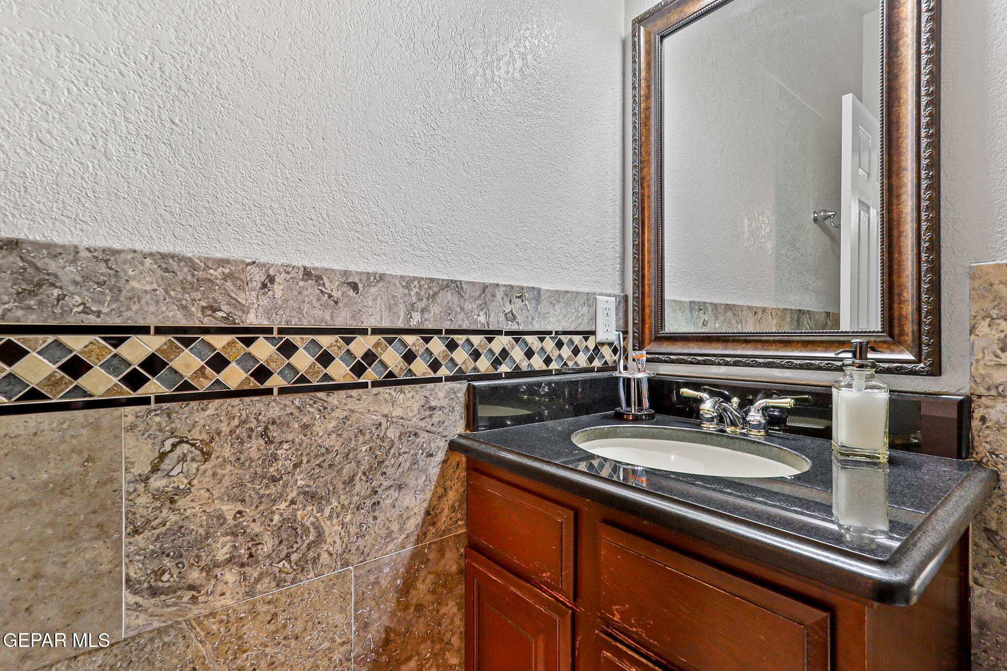 6544 Royal Ridge Drive El Paso, TX 79912 - Photo 26 of 58 a bathroom with a sink and a mirror