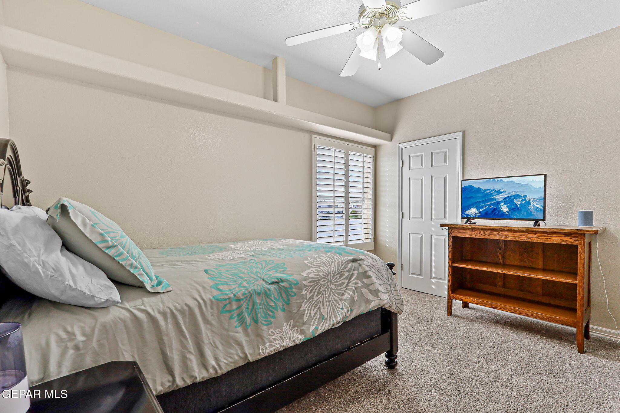 6544 Royal Ridge Drive El Paso, TX 79912 - Photo 29 of 58 a bedroom with a bed and a chandelier