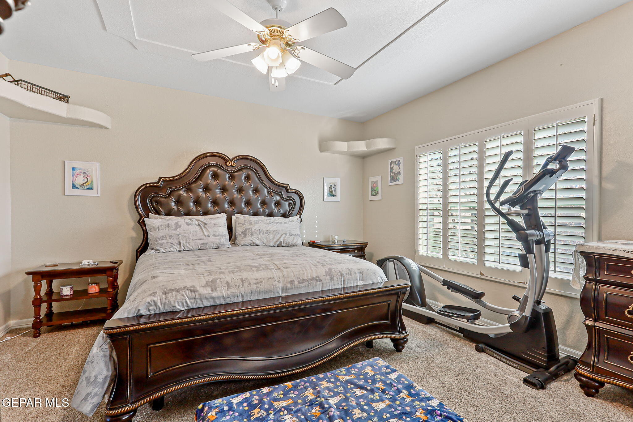 6544 Royal Ridge Drive El Paso, TX 79912 - Photo 36 of 58 a bedroom with a bed a chandelier and a window