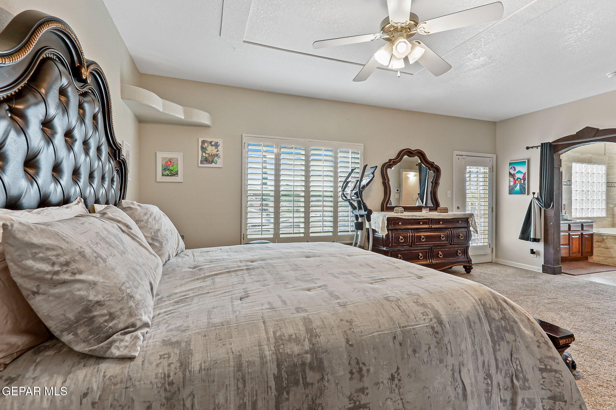 6544 Royal Ridge Drive El Paso, TX 79912 - Photo 37 of 58 a bedroom with a bed dresser and a flat tv screen
